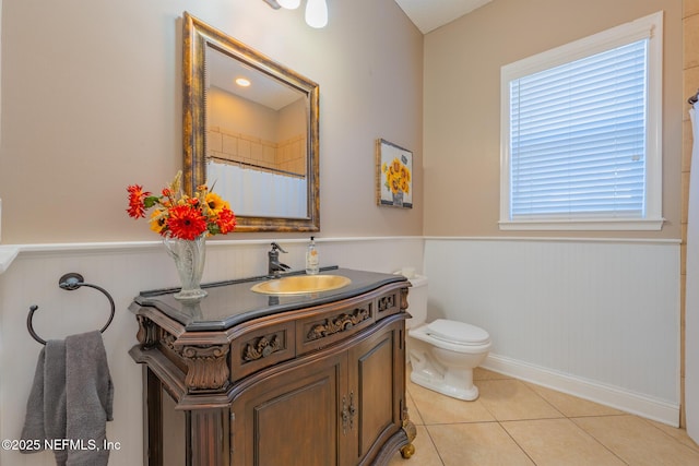 bathroom featuring toilet, vanity, tile patterned floors, and a shower with shower curtain