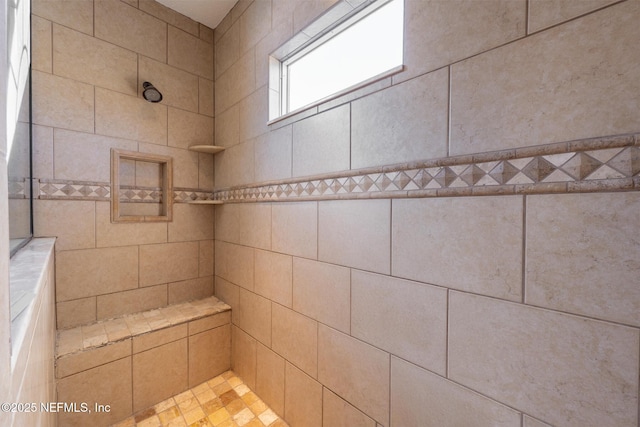 bathroom with a tile shower