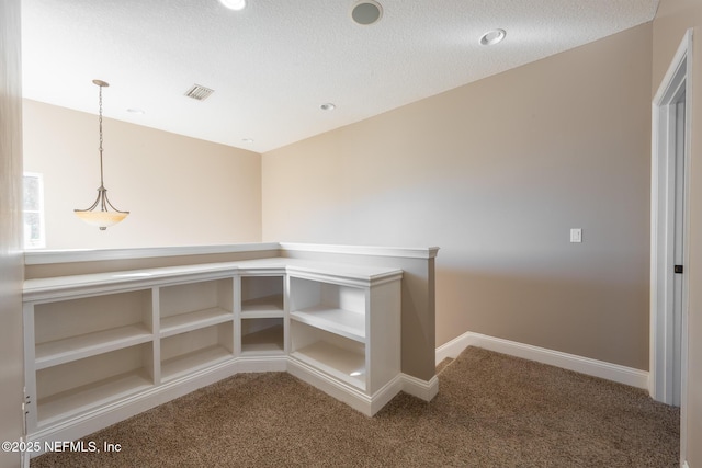 unfurnished office with carpet flooring and a textured ceiling