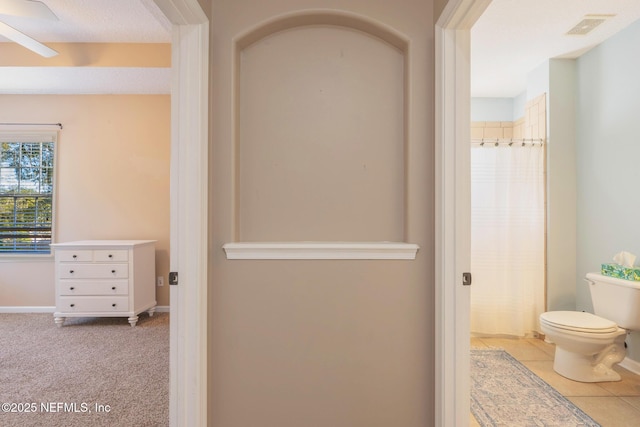 bathroom with a shower with curtain and toilet