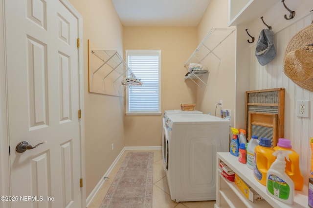 laundry area featuring light tile patterned floors and washing machine and clothes dryer