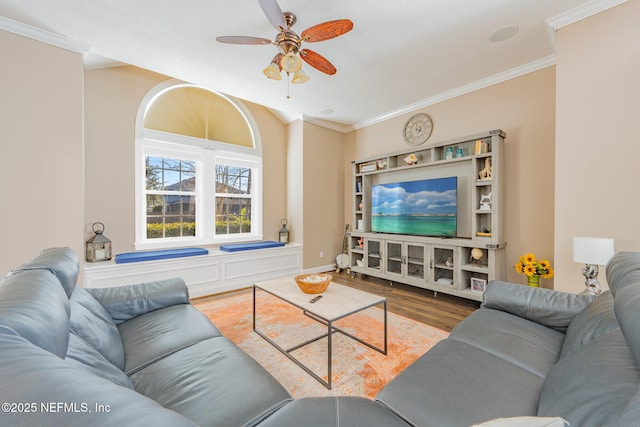 living room with hardwood / wood-style floors, ceiling fan, and crown molding