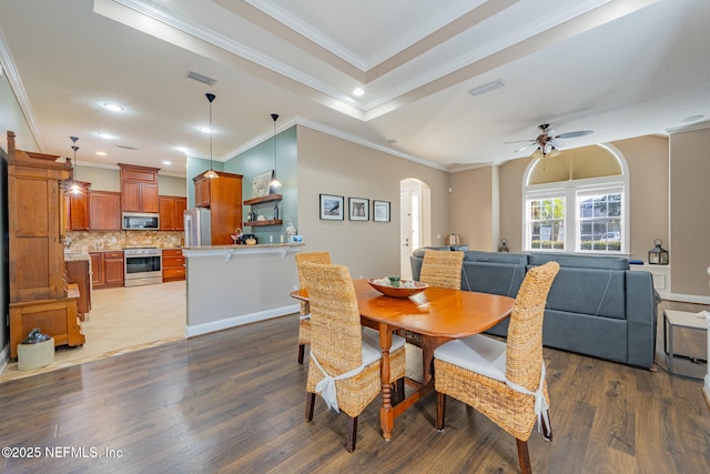 dining room featuring ceiling fan, light wood-type flooring, and ornamental molding