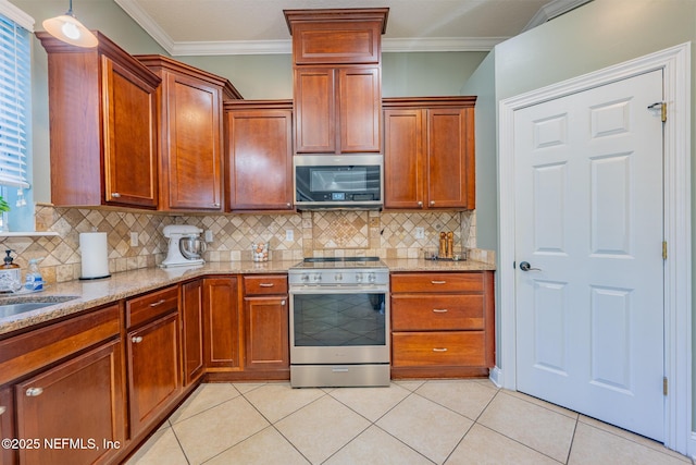 kitchen featuring light tile patterned flooring, light stone counters, appliances with stainless steel finishes, and tasteful backsplash