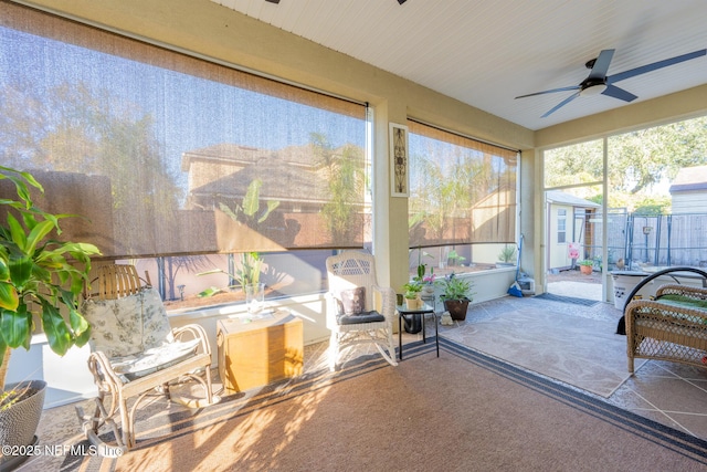 sunroom featuring ceiling fan