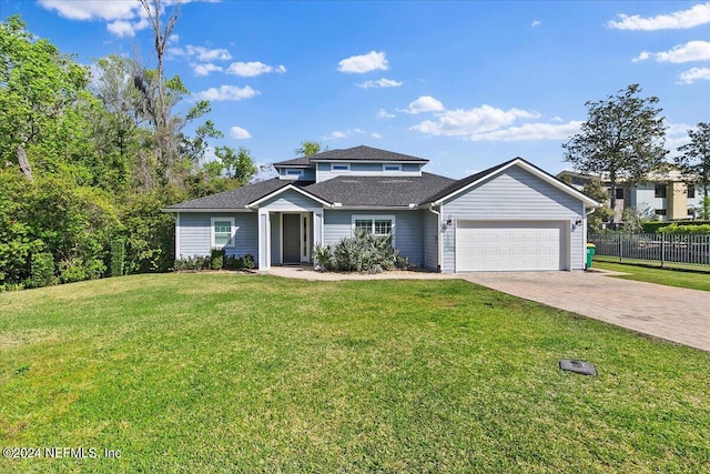 view of front property featuring a front lawn and a garage