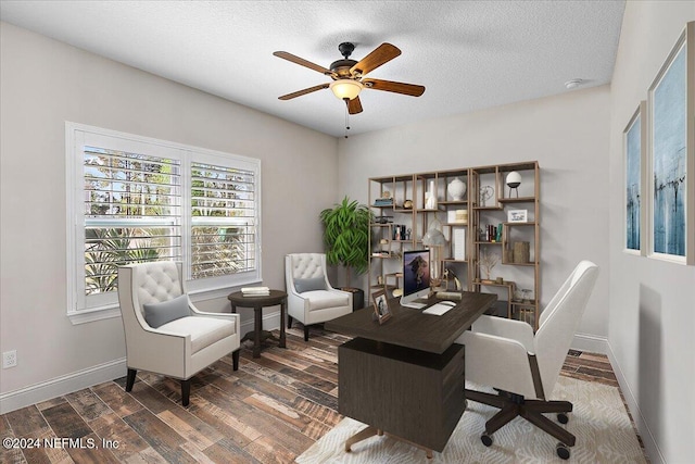 home office featuring ceiling fan, dark hardwood / wood-style flooring, and a textured ceiling