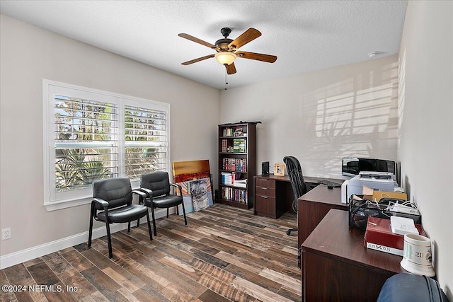 home office with a textured ceiling, dark hardwood / wood-style floors, and ceiling fan