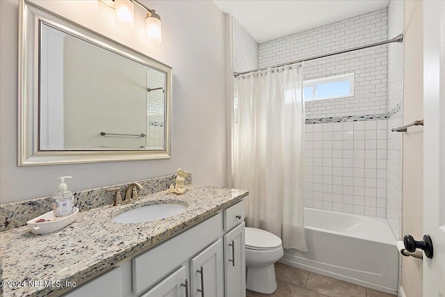 full bathroom featuring tile patterned flooring, vanity, toilet, and shower / bath combo with shower curtain