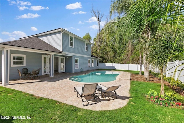 view of pool featuring a patio and a lawn