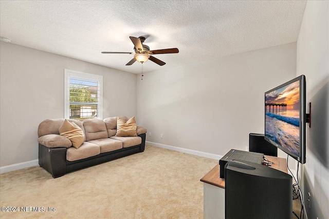 carpeted living room featuring ceiling fan and a textured ceiling