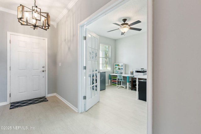 foyer entrance featuring ceiling fan with notable chandelier and ornamental molding