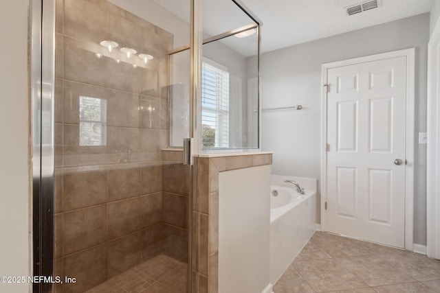 bathroom with tile patterned flooring and independent shower and bath