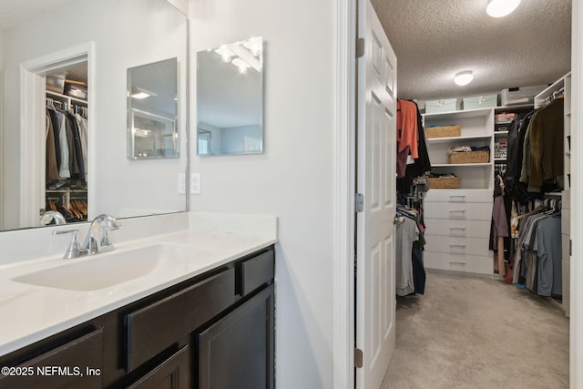 bathroom featuring vanity and a textured ceiling