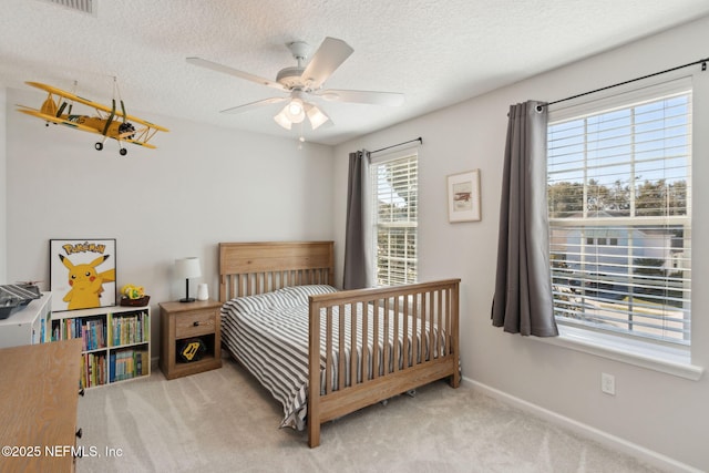 bedroom with light carpet, a textured ceiling, and ceiling fan