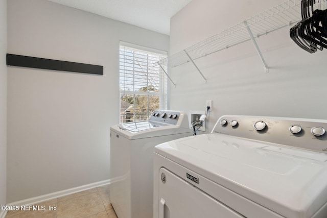 washroom featuring washer and dryer and light tile patterned floors