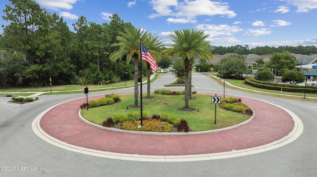 view of home's community with a yard