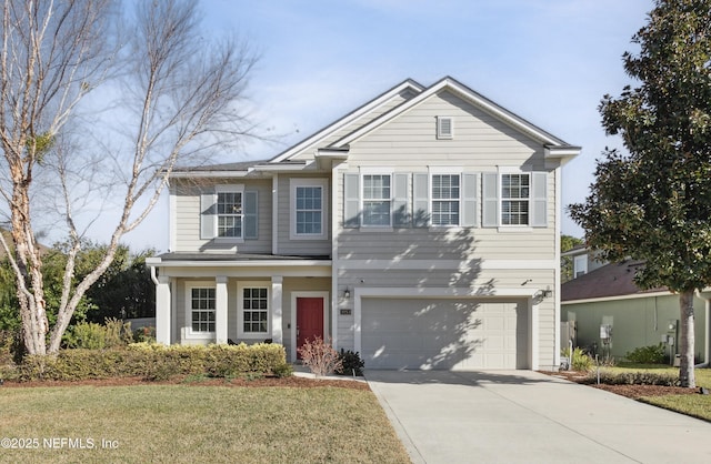 view of front of property with a garage and a front yard