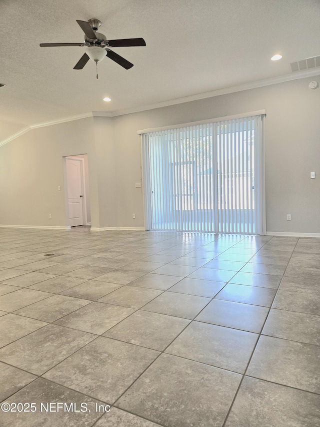 spare room with ceiling fan, crown molding, and light tile patterned floors