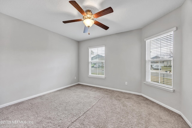 carpeted empty room featuring ceiling fan