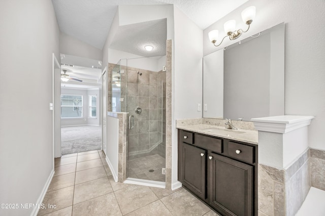 bathroom with vanity, a shower with door, lofted ceiling, ceiling fan, and a textured ceiling