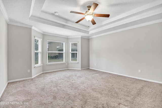 carpeted spare room with a raised ceiling, ceiling fan, a textured ceiling, and ornamental molding