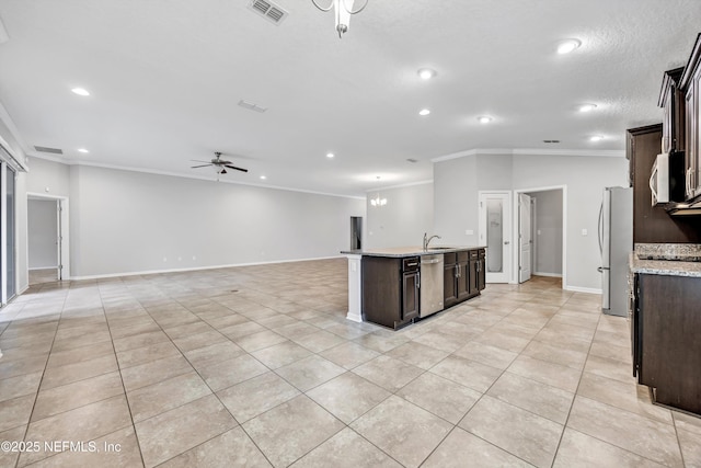 kitchen with dark brown cabinetry, a center island with sink, stainless steel appliances, and ornamental molding