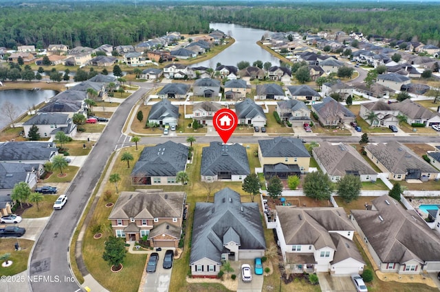 birds eye view of property with a water view