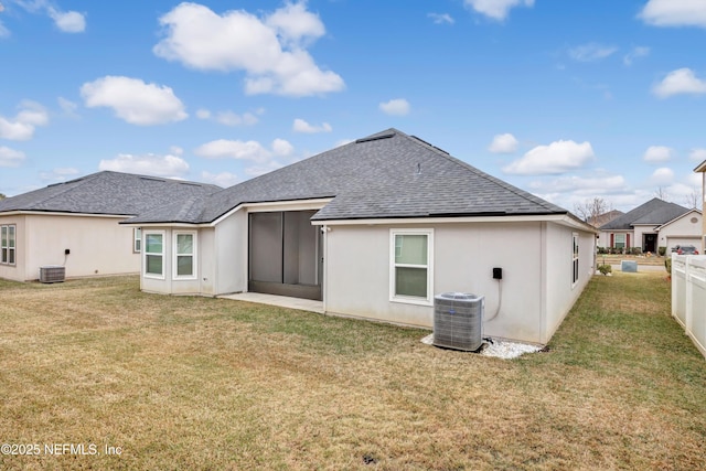 back of property featuring a yard, central AC, and a sunroom