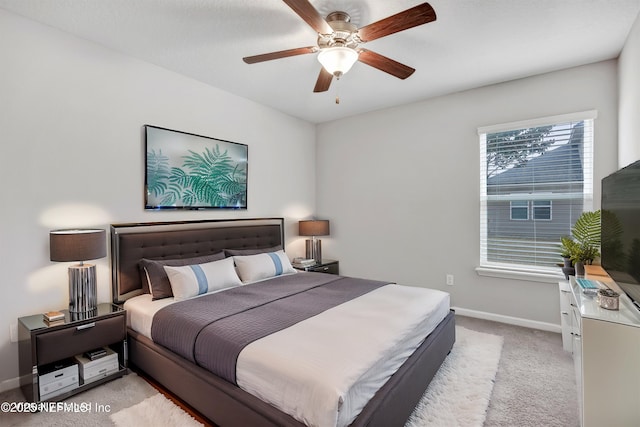 bedroom featuring ceiling fan and light carpet