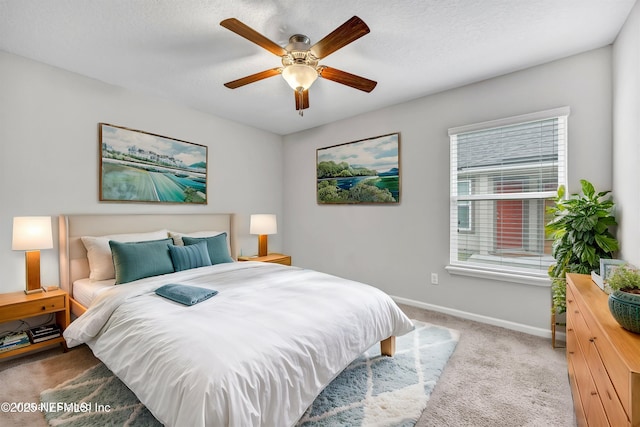 carpeted bedroom with a textured ceiling and ceiling fan