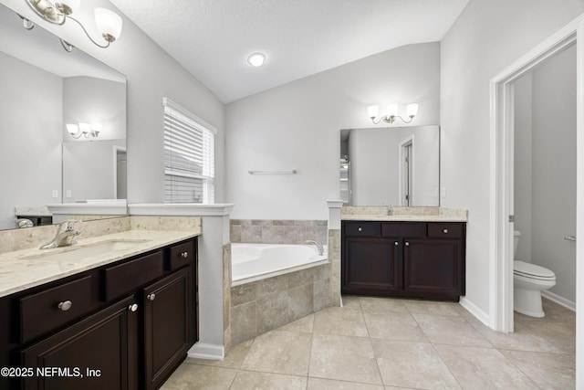 bathroom featuring vanity, lofted ceiling, tile patterned floors, toilet, and tiled tub