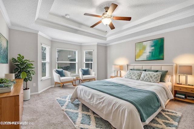 bedroom with a tray ceiling, ceiling fan, and ornamental molding