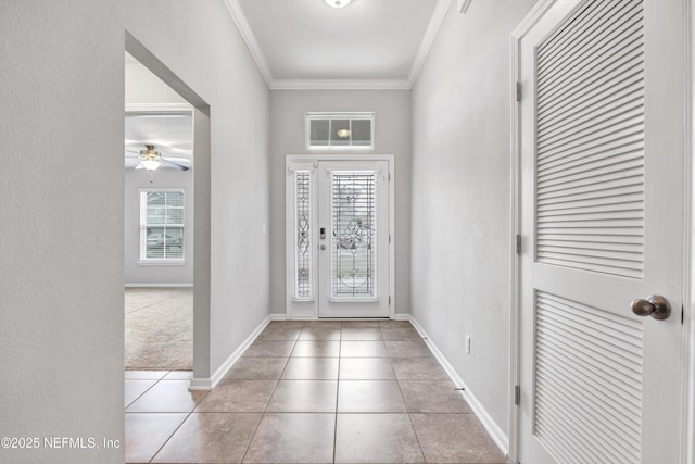 foyer with light tile patterned floors, ceiling fan, and crown molding