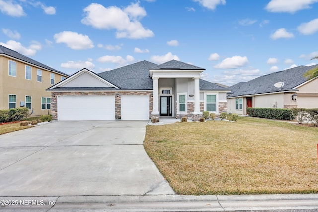 view of front of home with a garage and a front lawn