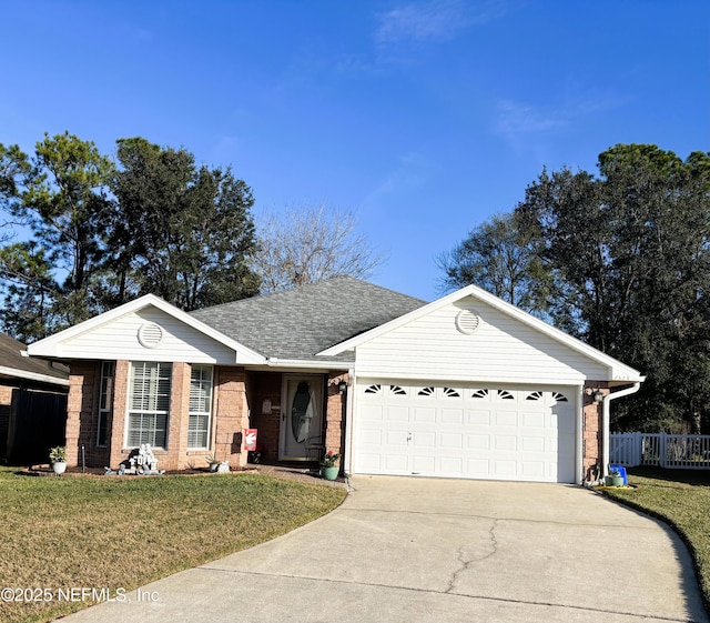 ranch-style home with a garage and a front lawn