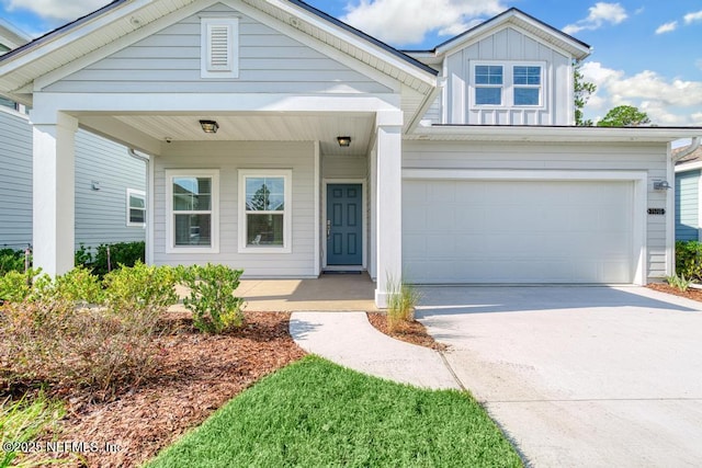 view of front of property featuring covered porch and a garage