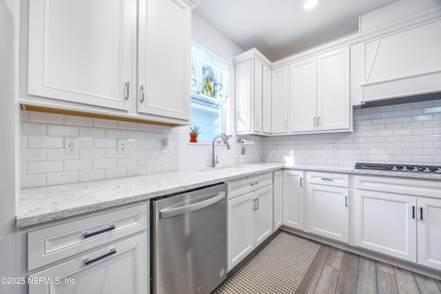 kitchen featuring light stone countertops, decorative backsplash, white cabinetry, and stainless steel dishwasher