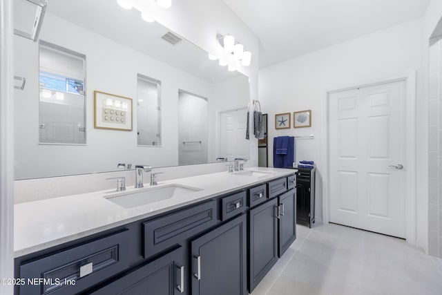 bathroom featuring vanity, tile patterned floors, and walk in shower