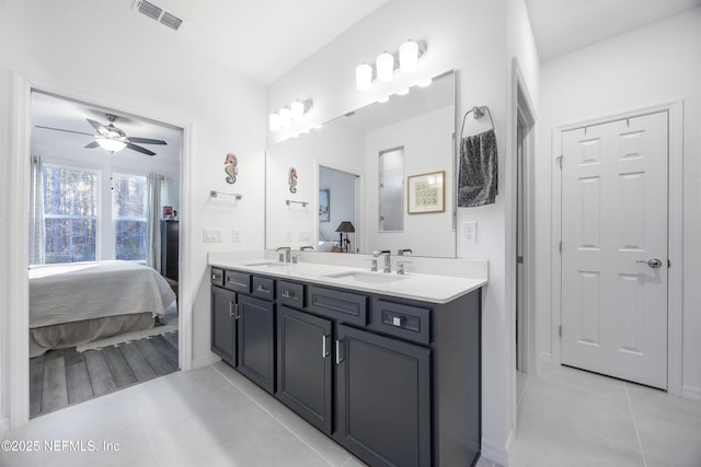 bathroom with tile patterned flooring, ceiling fan, and vanity