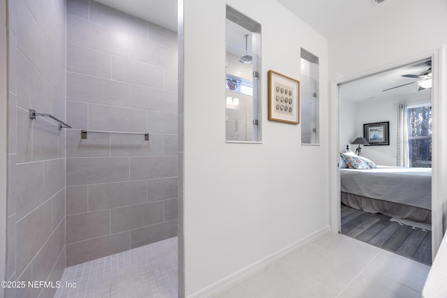 bathroom with tile patterned floors, ceiling fan, and tiled shower