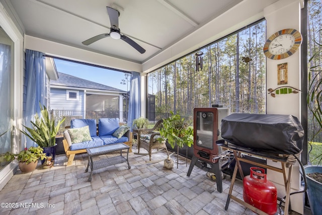 sunroom featuring ceiling fan