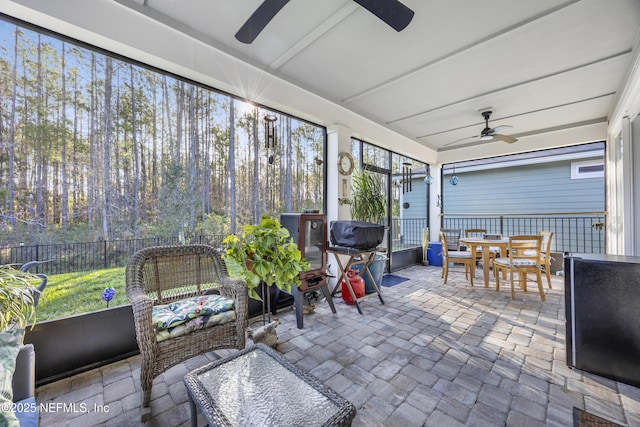 sunroom featuring ceiling fan