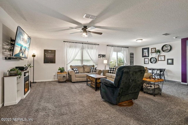 living room with carpet, a textured ceiling, and ceiling fan