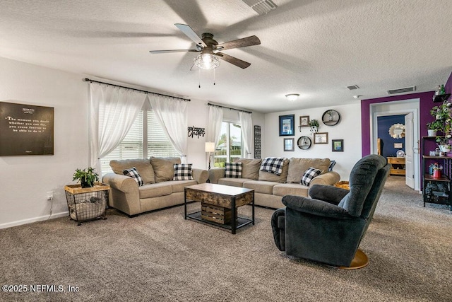 carpeted living room featuring ceiling fan and a textured ceiling