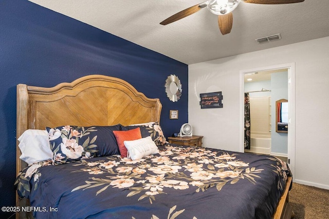 bedroom with ensuite bath, ceiling fan, carpet, and a textured ceiling