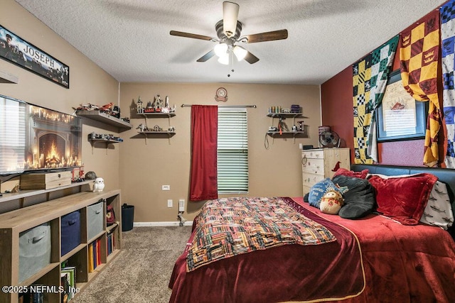 bedroom with a fireplace, a textured ceiling, carpet floors, and ceiling fan