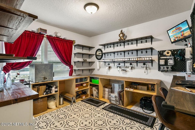 interior space with butcher block counters and a textured ceiling