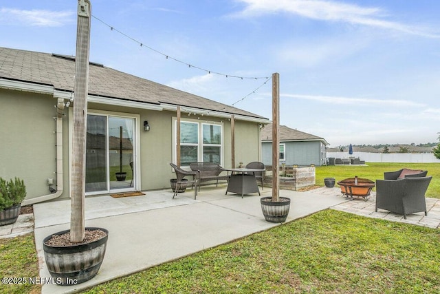 rear view of house featuring a lawn, a patio area, and an outdoor living space with a fire pit