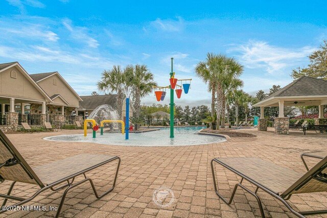 exterior space featuring a gazebo and pool water feature